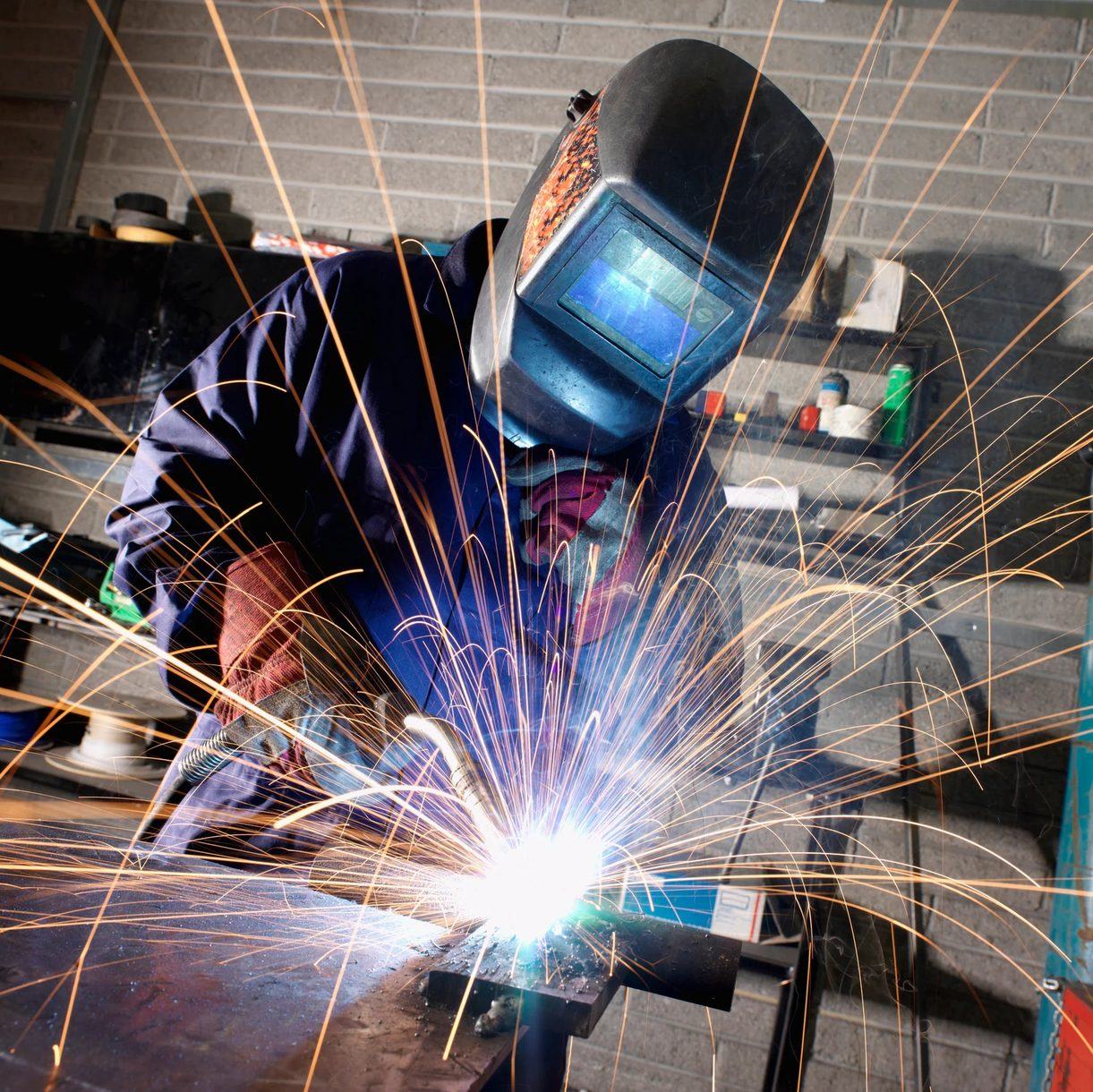 Welder fabricating steel in a metal shop