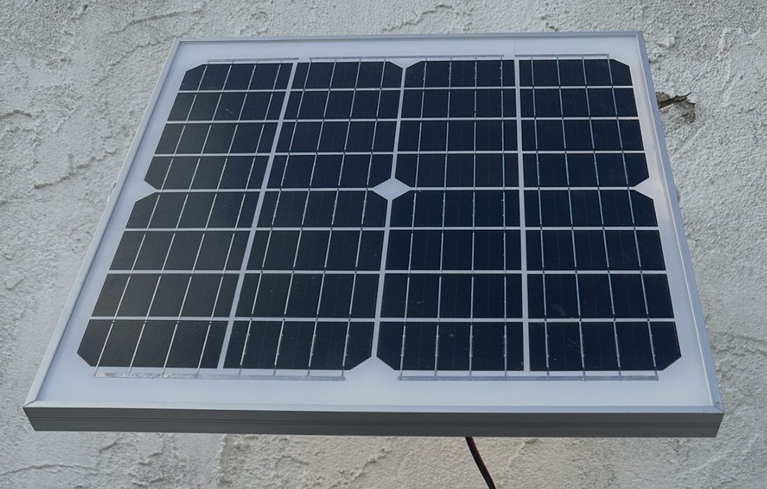 Small solar panel mounted on a wall, the kind used to power a gate keypad or lock